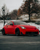 Red Nissan 350z with Aftermarket Cosmis Wheels XT-206R Black 18x11 +8mm Squared